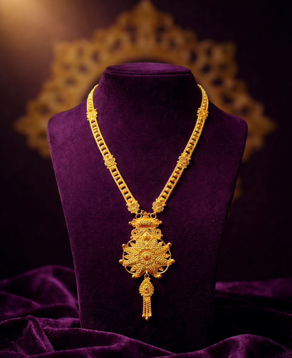 Gold necklace on a purple mannequin against a dark background